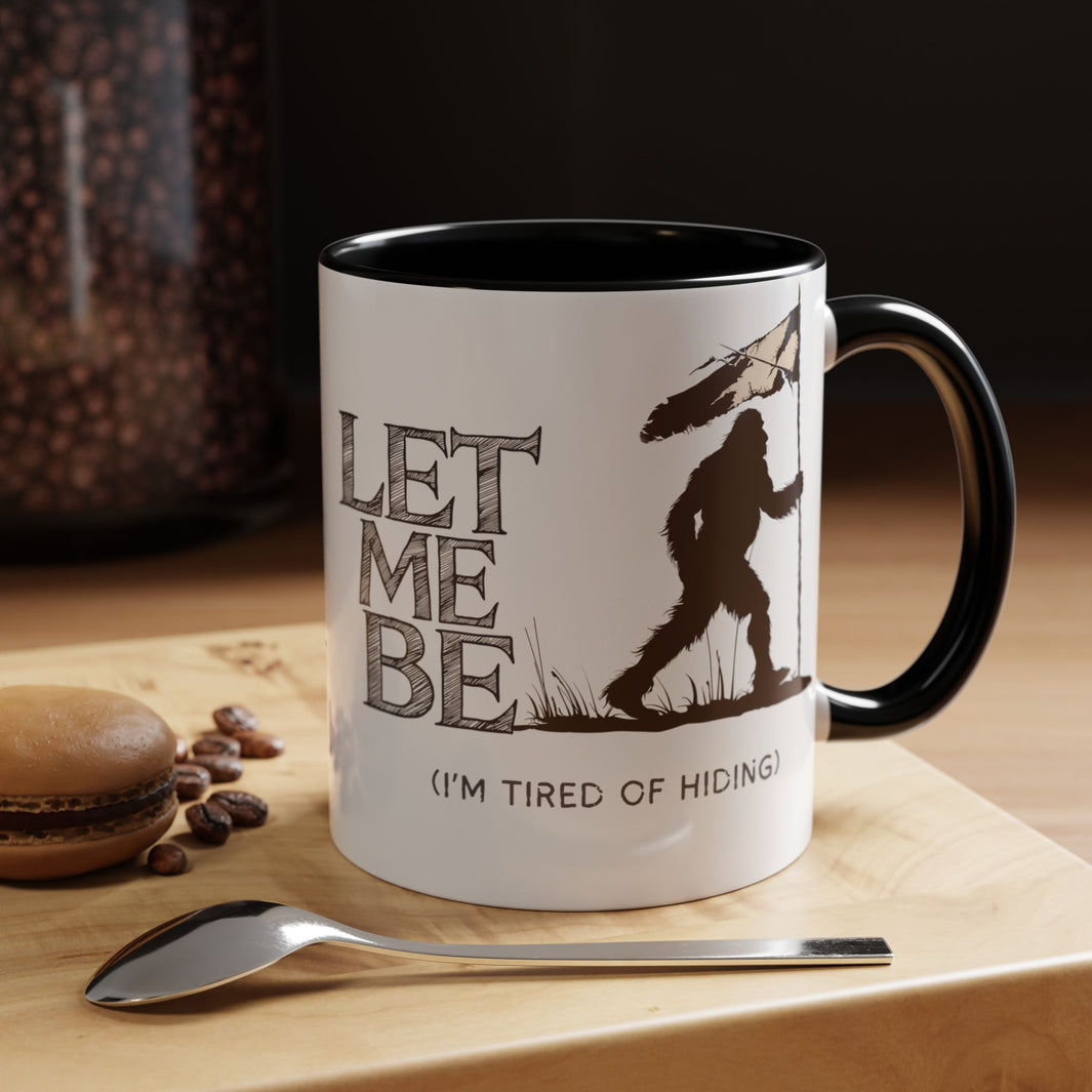 a coffee mug on table bigfoot is roaming the woods with the caption Let Me Be I'm Tired Of Hiding