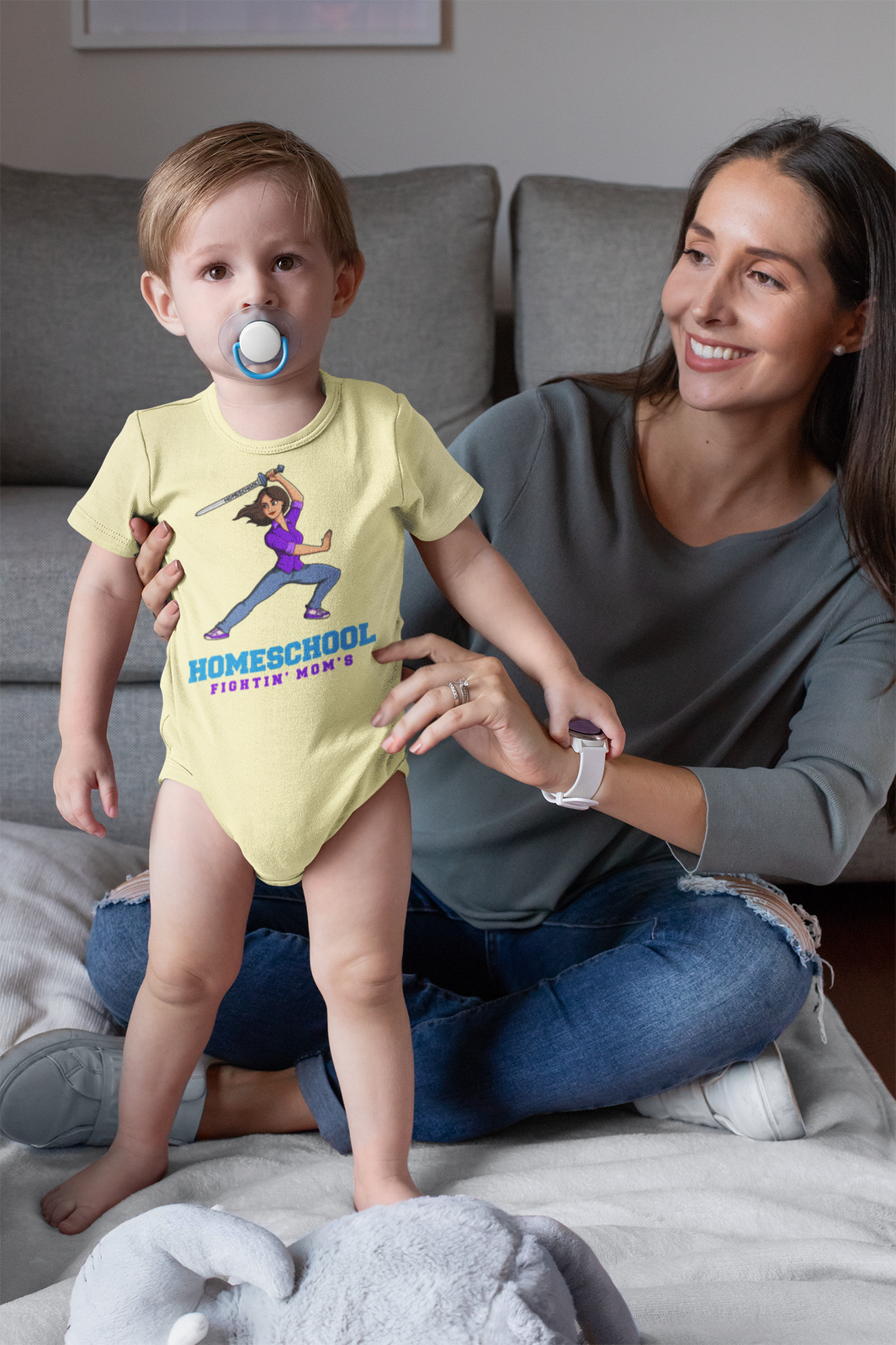 a cute baby with mom in a fightin's mom's onesie